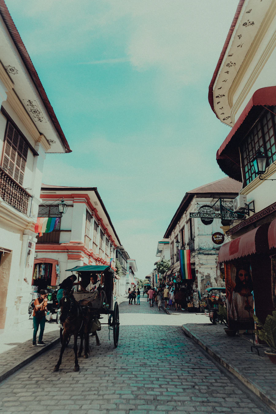 A horse-drawn calesa on a stone street lined with old Spanish-era houses in Vigan